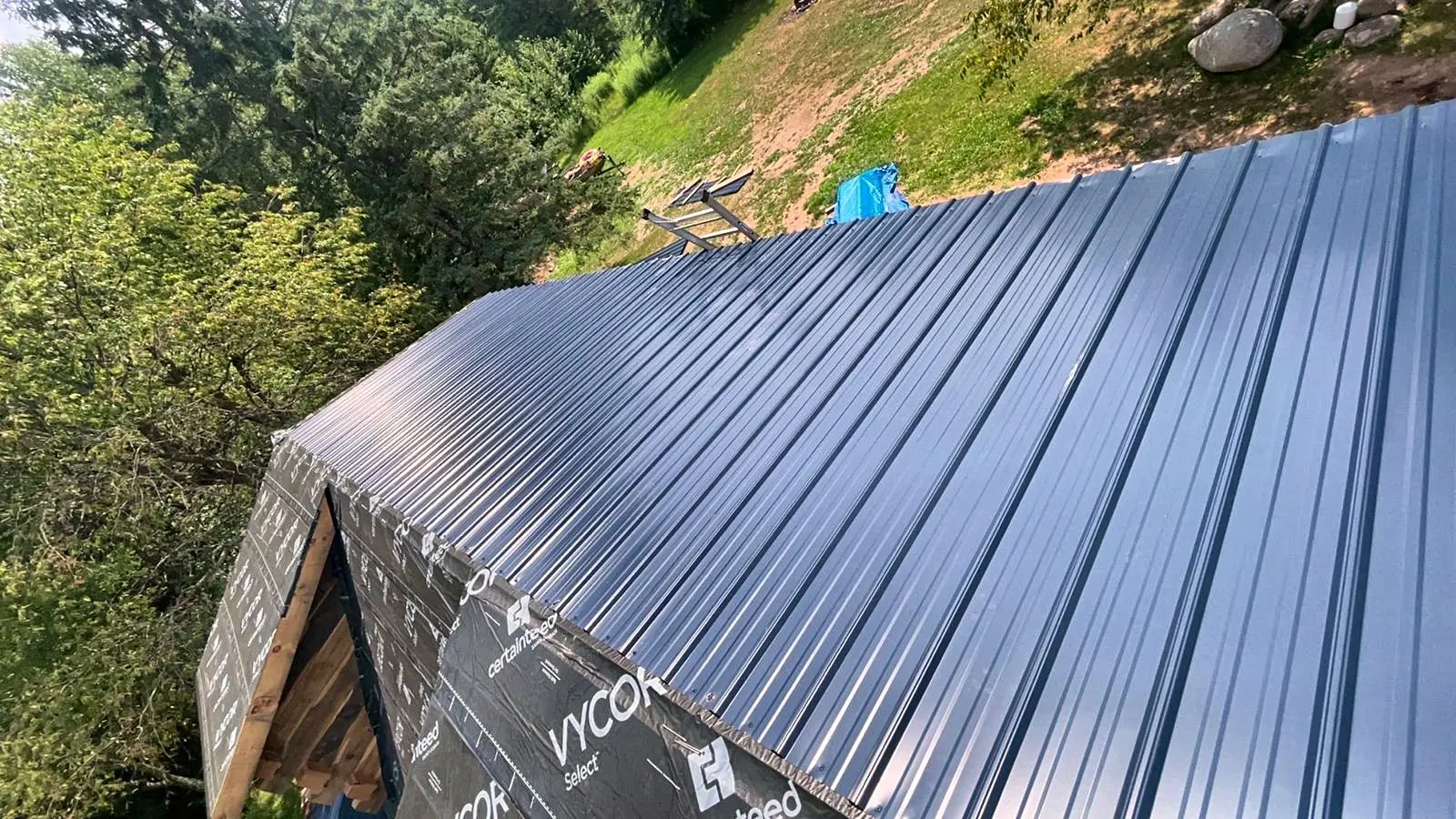 Standing-seam metal roofing detail on a finished build